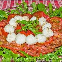 Grillbeilagen: salat von rucola, tomate und mozzarella-kügelchen