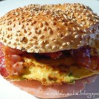 Frühstücks-Bagel mit Frischkäse, Rührei, Schinken und Speck